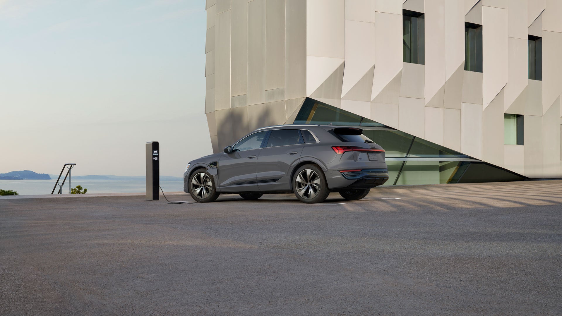 Side profile of an Audi Q8 e-tron charging.